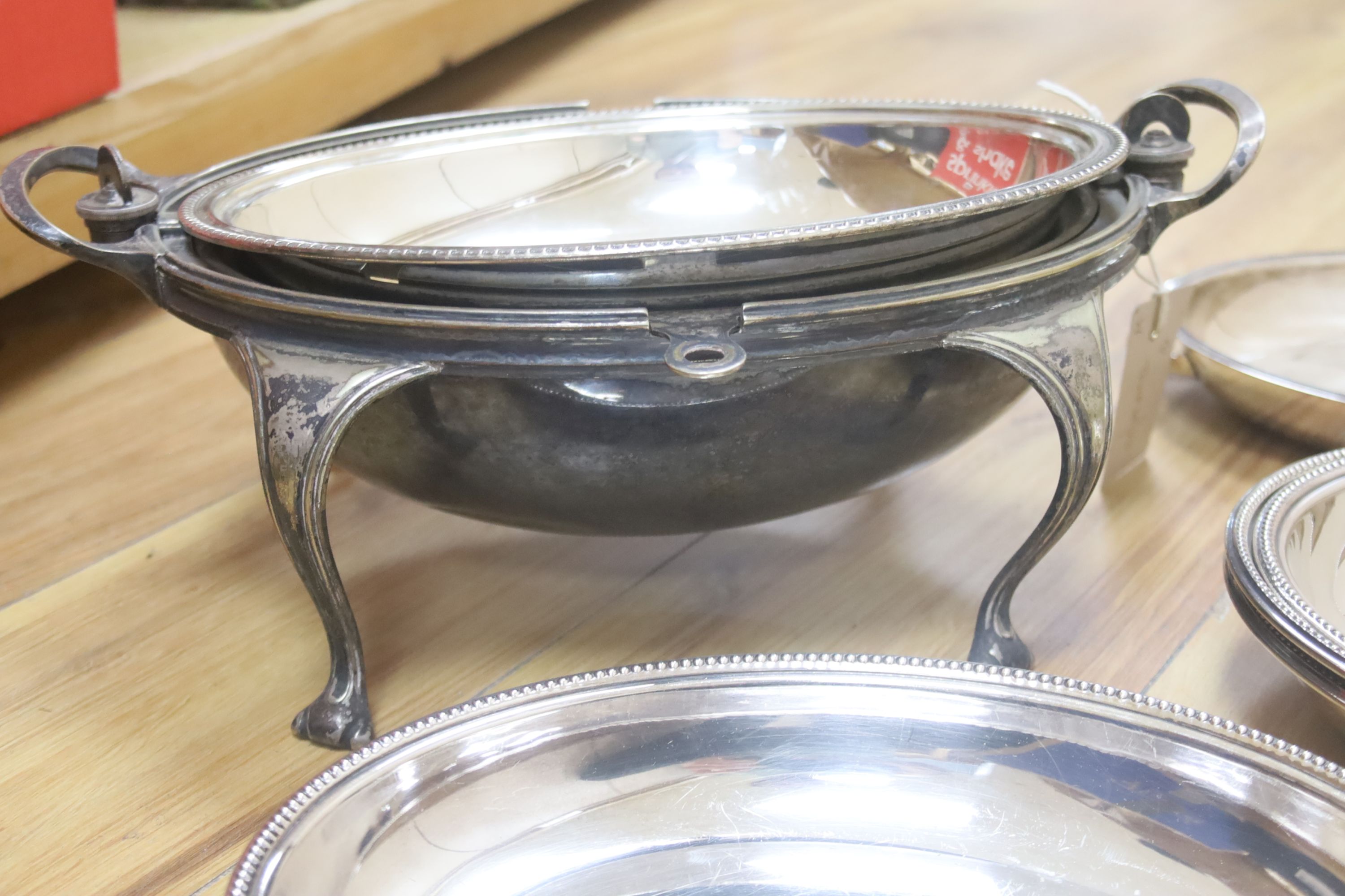 A collection of plated serving dishes, including an oval roll-top breakfast dish, two pairs of entree dishes and covers and two other entree dishes and covers (one missing handle)